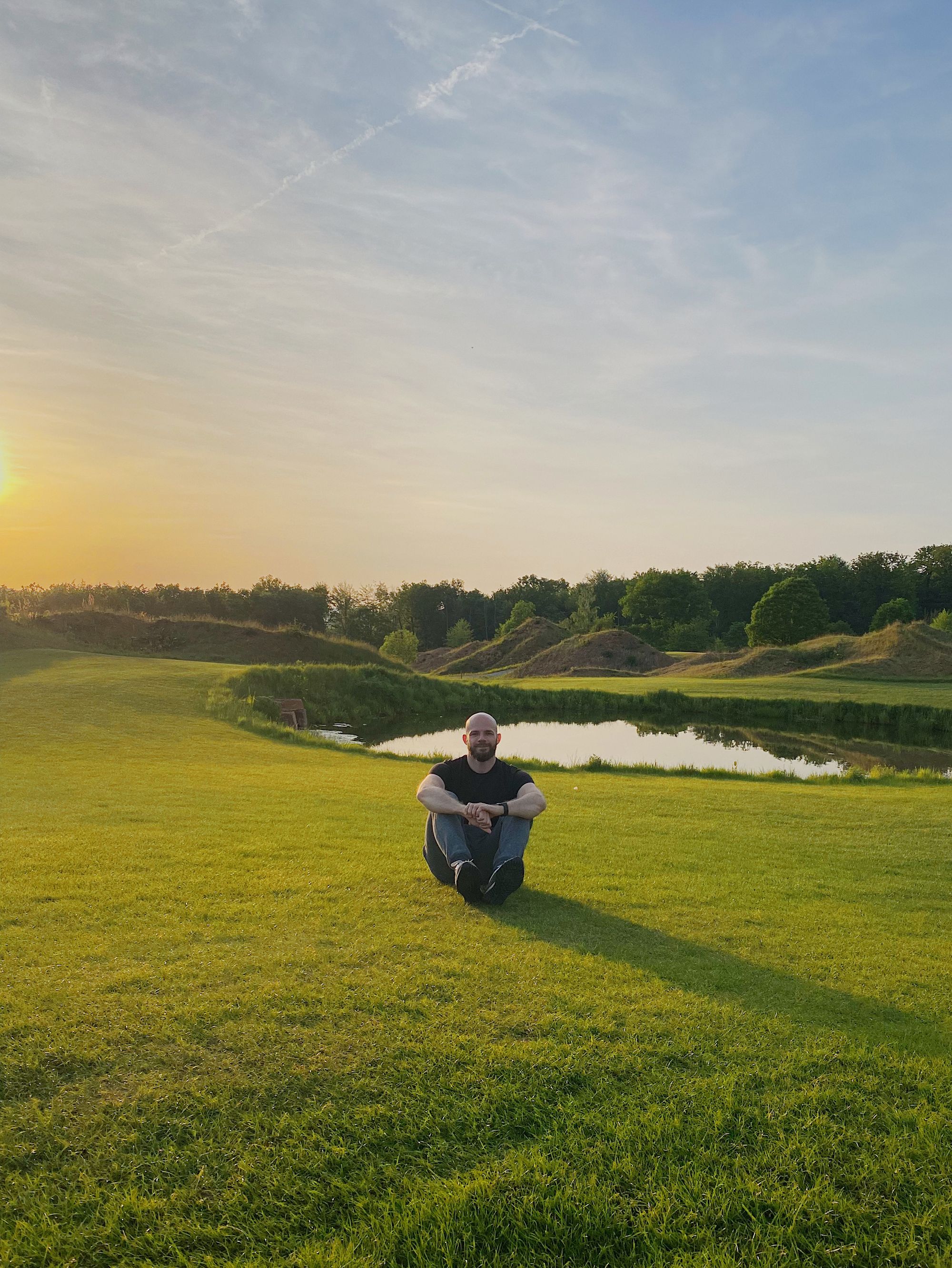 Resting on a grass field during sunset after our first day of this road trip