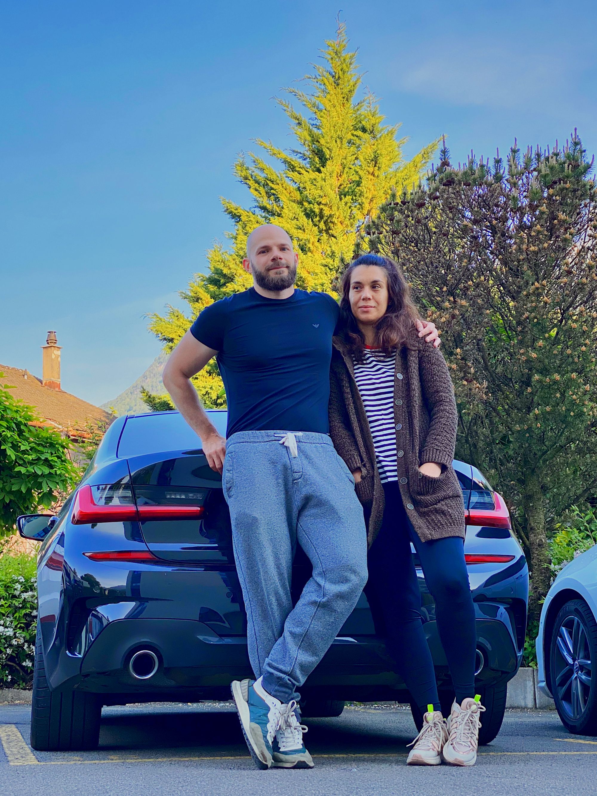 Us two resting on the back of our car, after putting the luggage in the trunk