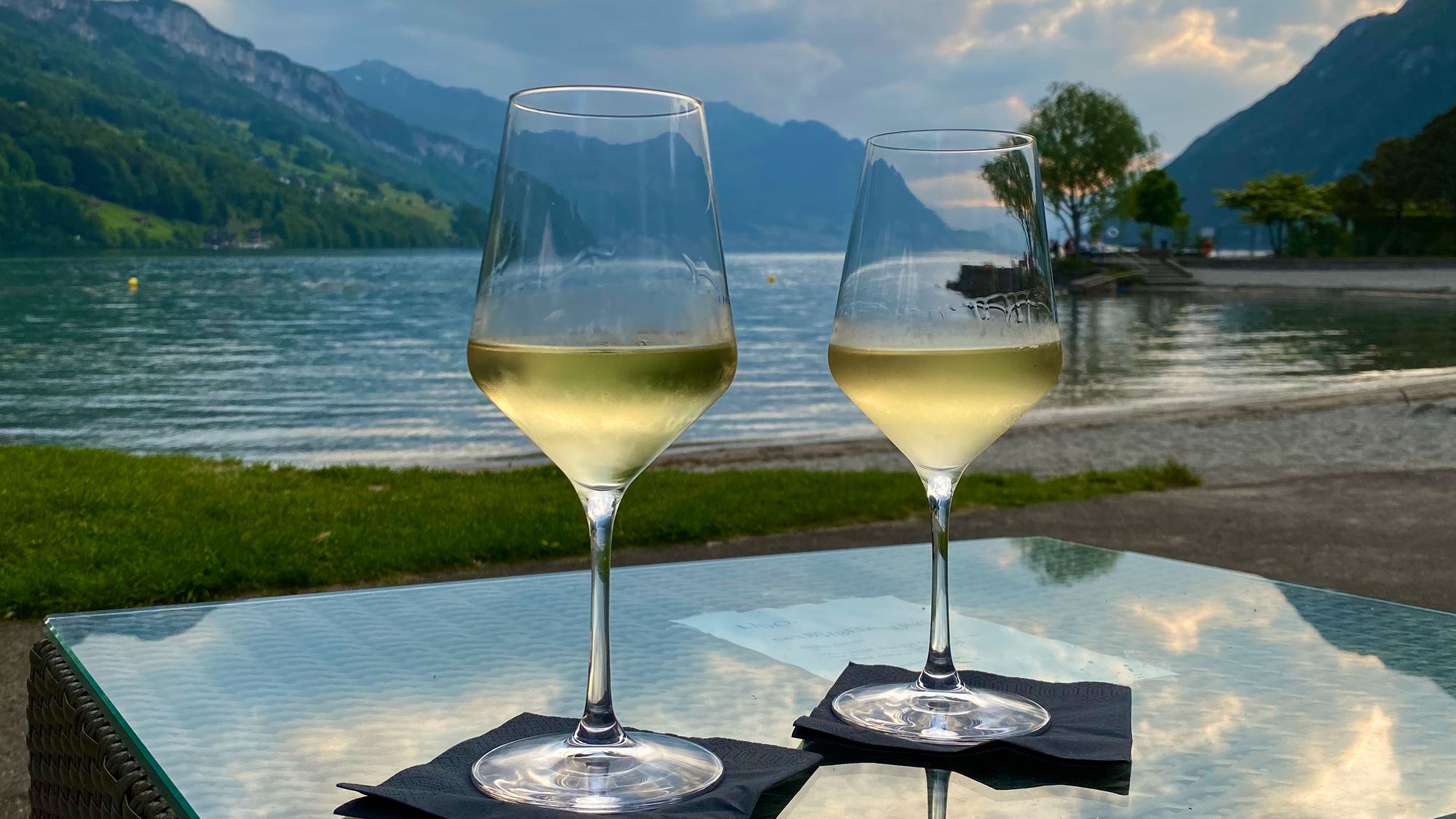 Sunset over lake Lucerne with two glasses of wine in front