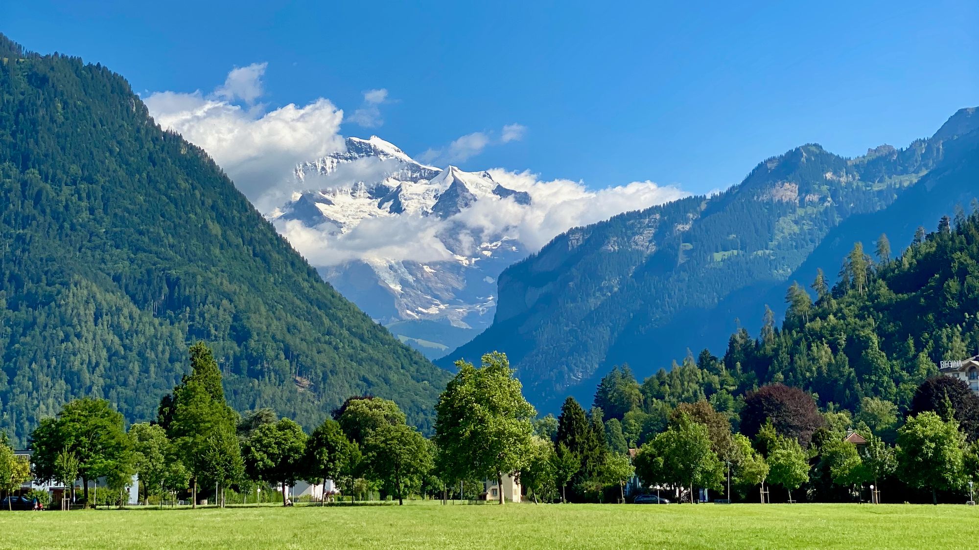 The Jungfrau mountain peeking through the clouds, viewed from Interlaken central park