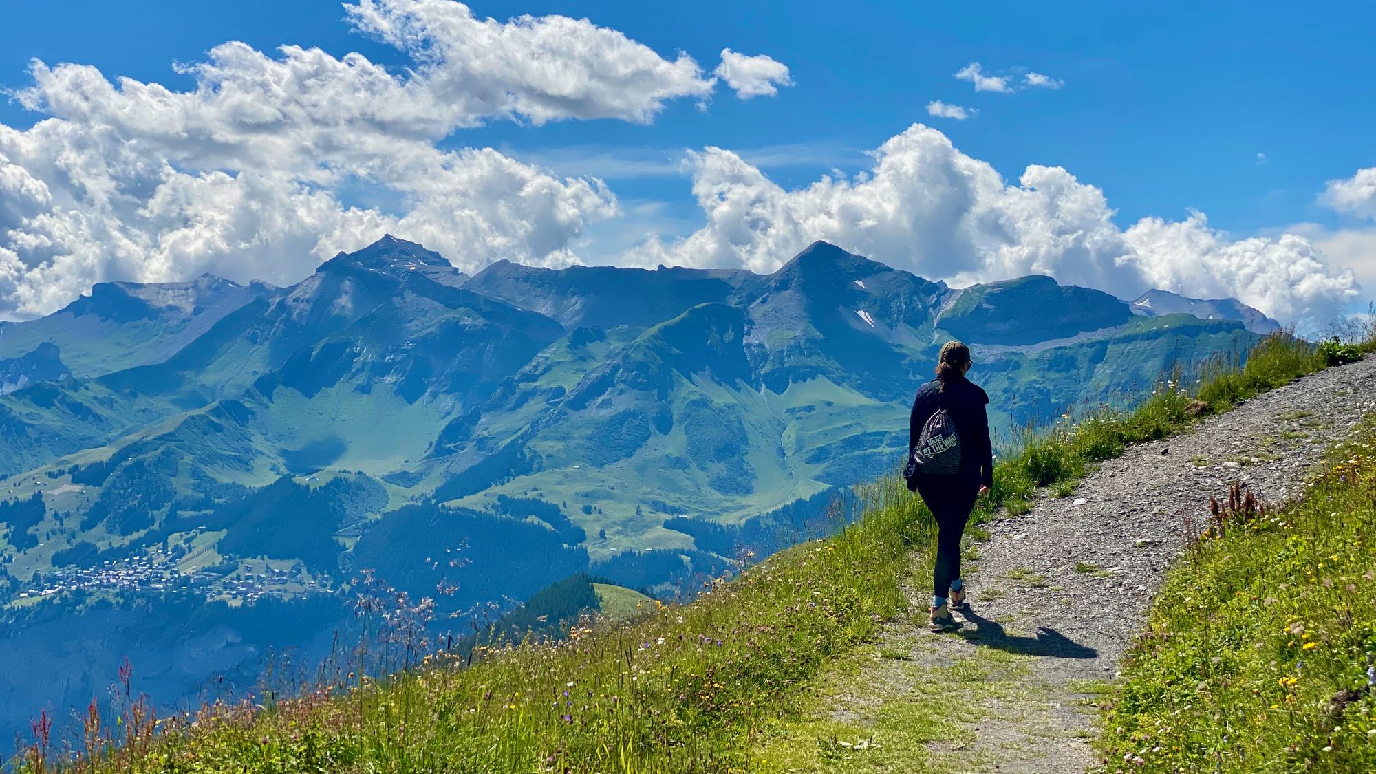 Silvia walking on a tipical panormal trail with moutains and valleys in the background