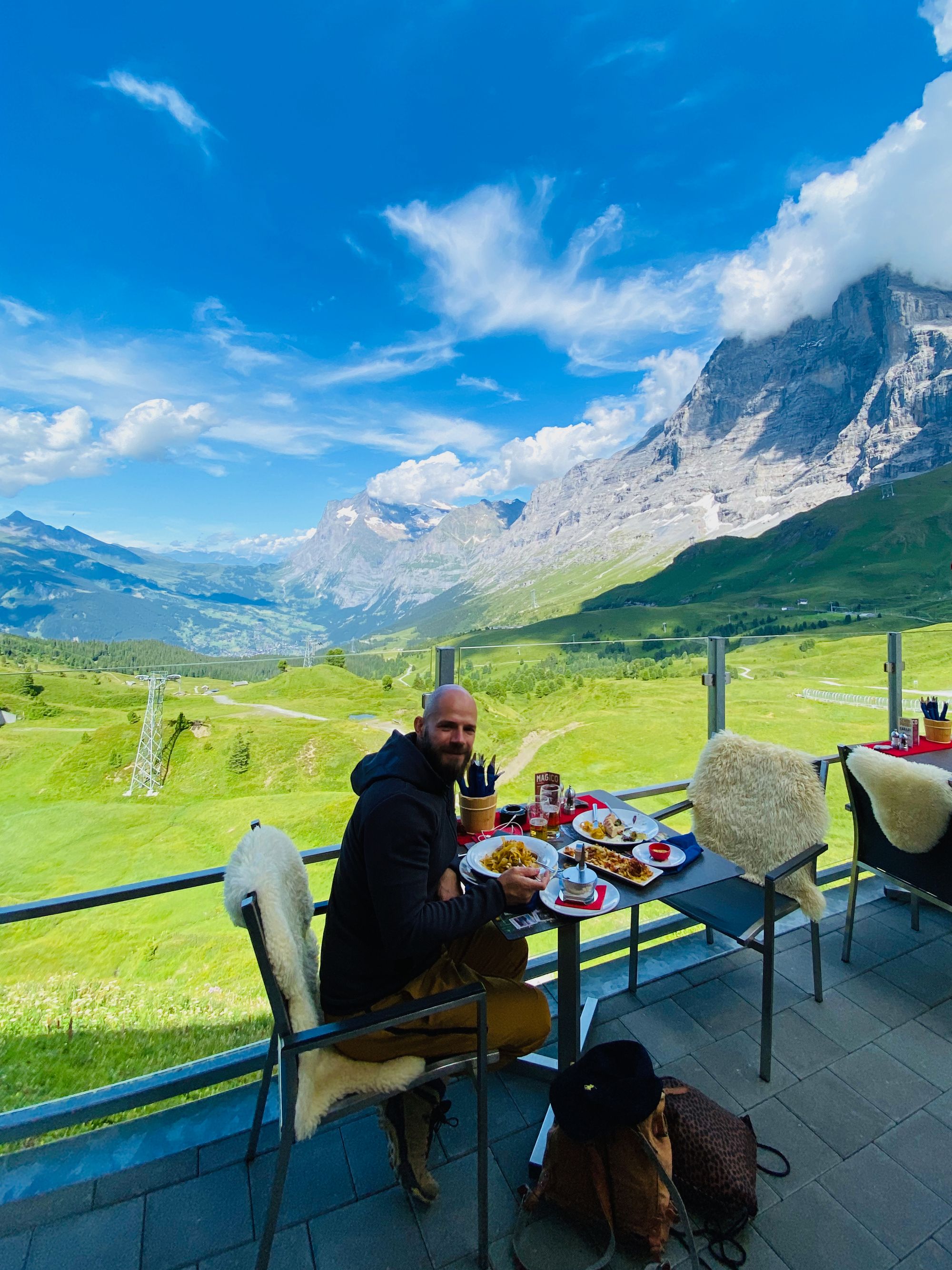 Me at the table of a panoramic terrace in Kleine Scheidegg