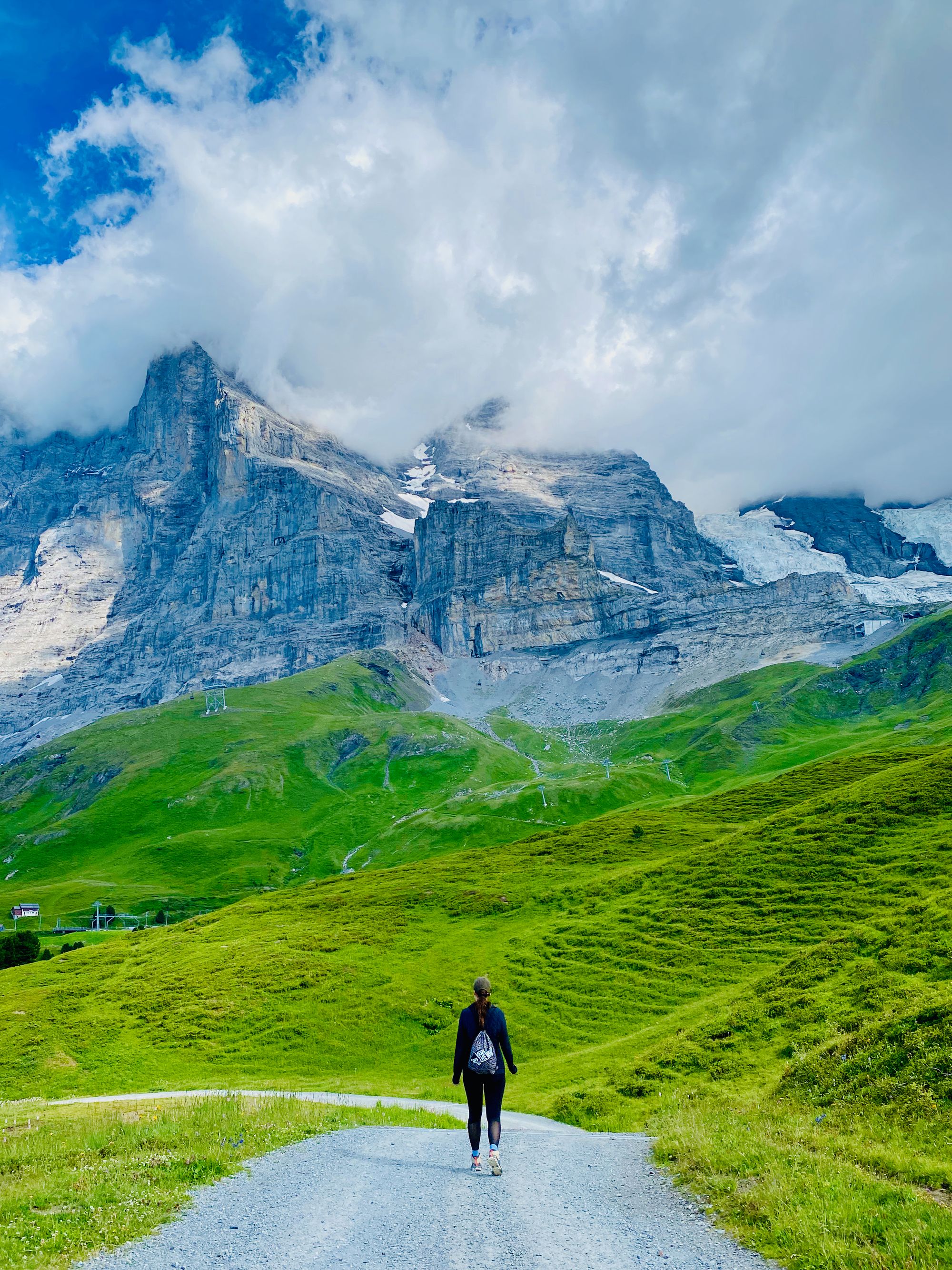 Silvia walking on a trail with Eiger north face in the background