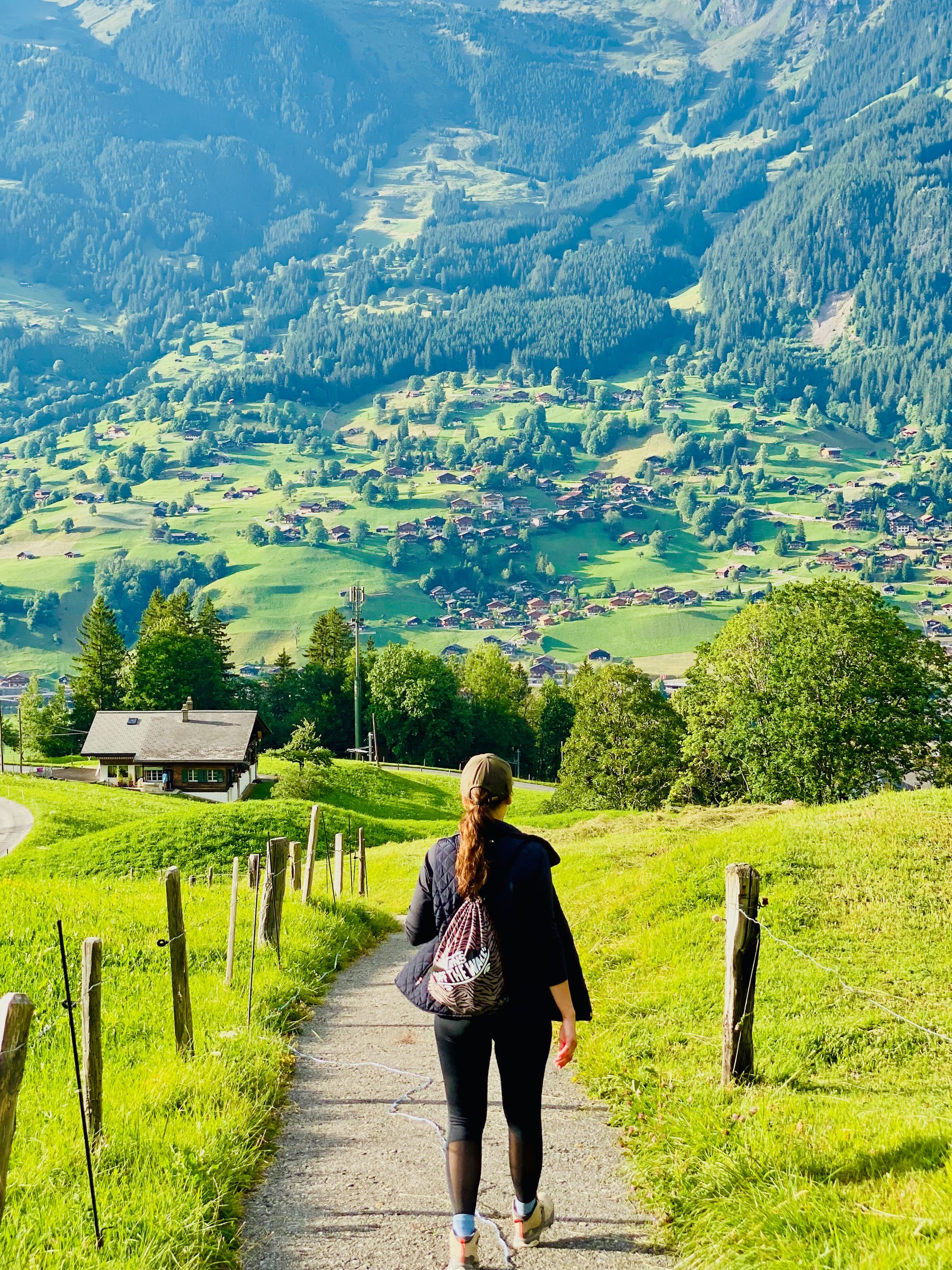 Silvia walking on trail approaching Grindelwald